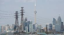 Electrical lines are seen in front of the Toronto skyline from the Portlands Energy Centre on Thursday, May 22, 2014. (Darren Calabrese For The Globe and Mail)